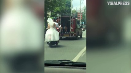 Bride In White Wedding Dress Riding Pillion On Motorcycle