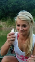 Girl Bites Head off Fish for Bait