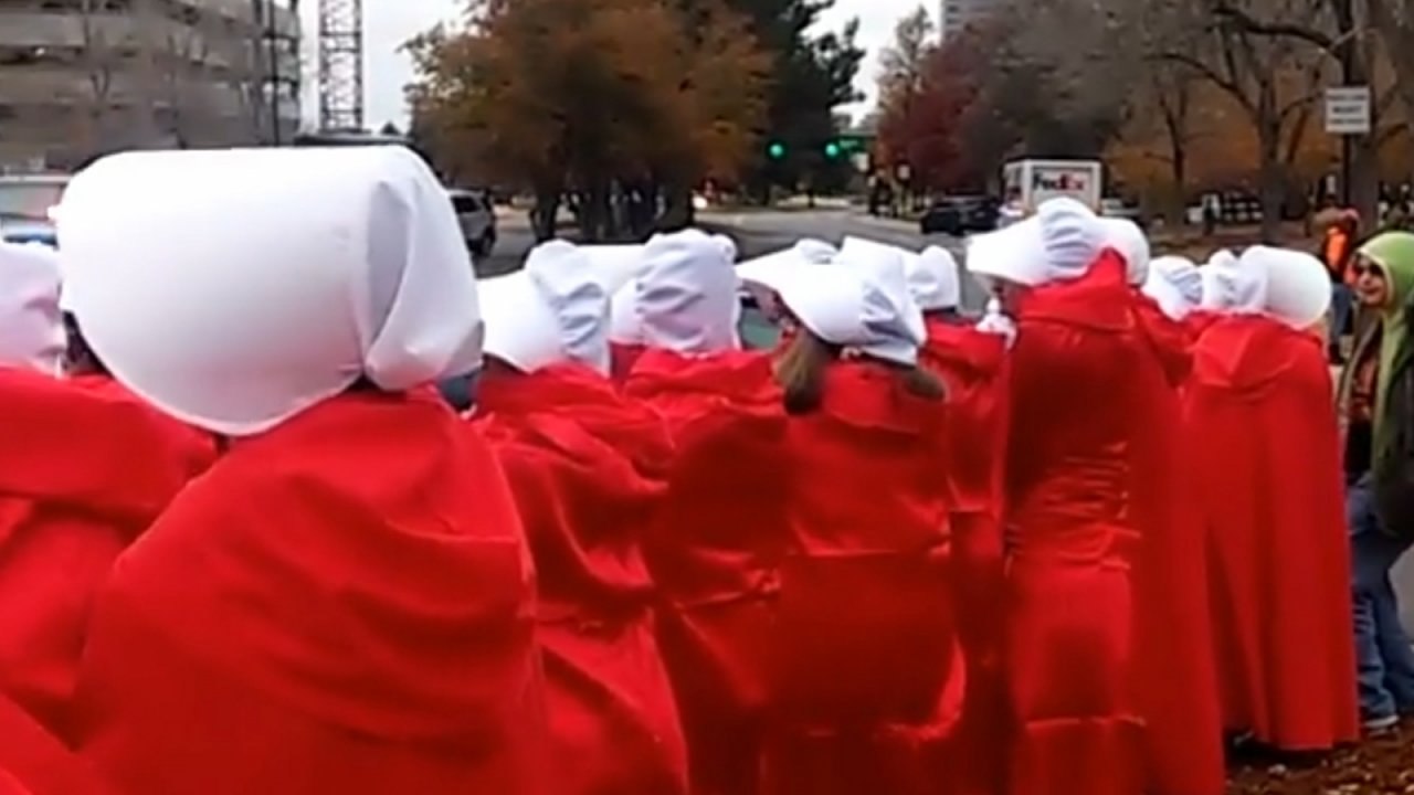 Mike Pence greeted by 'Handsmaids' in Denver