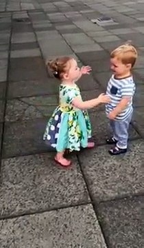 Baby boy kissing baby girl