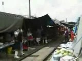 Train Drives Through A Bangkok Market