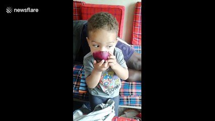 Boy, 1, eats an onion like it's an apple