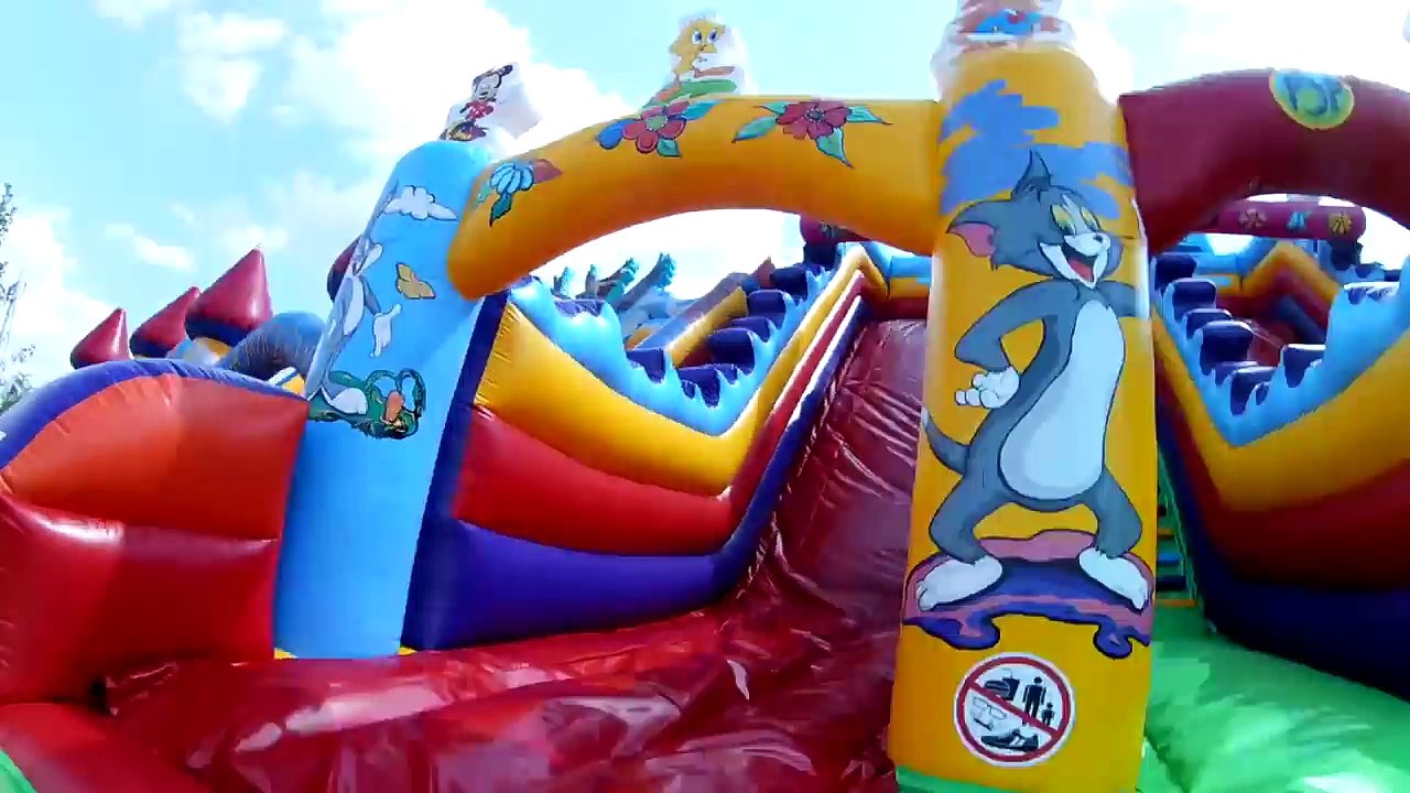 Outdoor playground fun for kids. Huge bouncy castle and water balls.