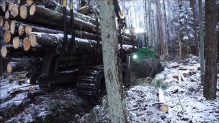 John Deere 1110E with big load in beautiful winter forest