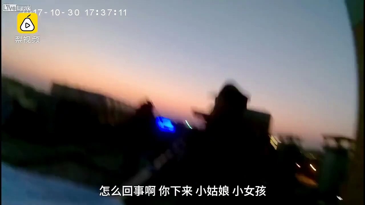 Suicide girl sitting on the edge of the roof gets pulled in by police
