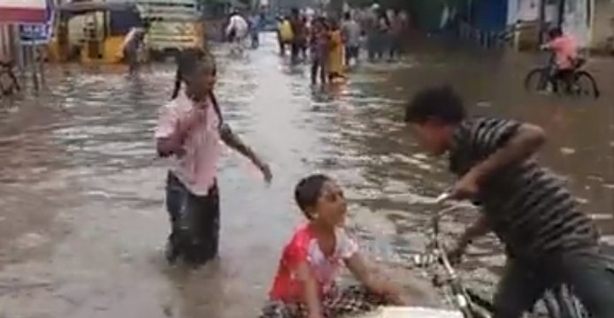 Children Play on Flooded Street as Heavy Rain Prompts School Closures in India