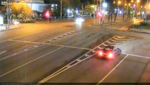 Two cars collide when traveling at high speeds into an intersection. One car ran a red light.