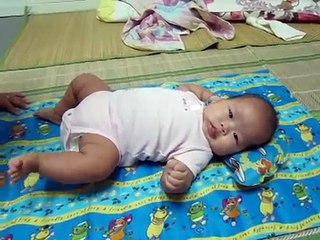 Three-month-old Tian leaned back on the floor