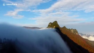 'Cloud waterfall' rolls down mountain in China