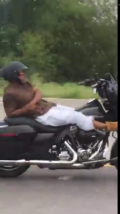 Guy rides motorcycle with no hands on freeway will leaning all the way back and then cuts across all lanes of traffic (with no hands)