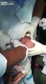 the doctor removes watch from baby's mouth