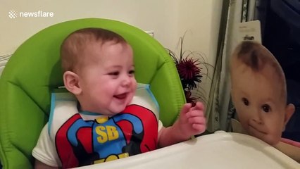 Too cute! UK baby giggles at cardboard cutout of baby