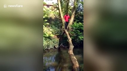 UK man falls in water trying to cross river on a log