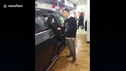 Car salesman gets head stuck when demonstrating door feature