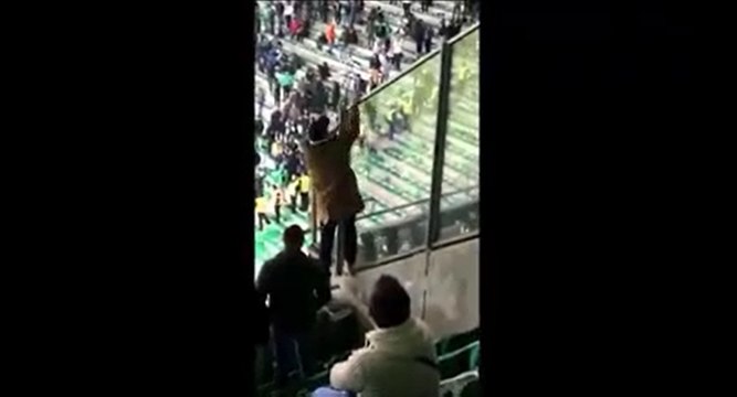 Un supporter Stéphanois pisse dans une bouteille et la balance sur les supporters Lyonnais.