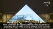 Images adorn Paris Louvre Pryamid as Abu Dhabi museum opens