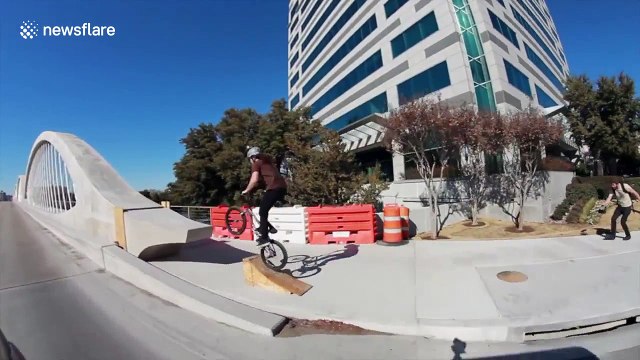 BMX biker rides over Ft. Worth 7th Street Bridge arches