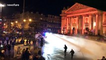 Riot police use water cannon on football fans in Brussels