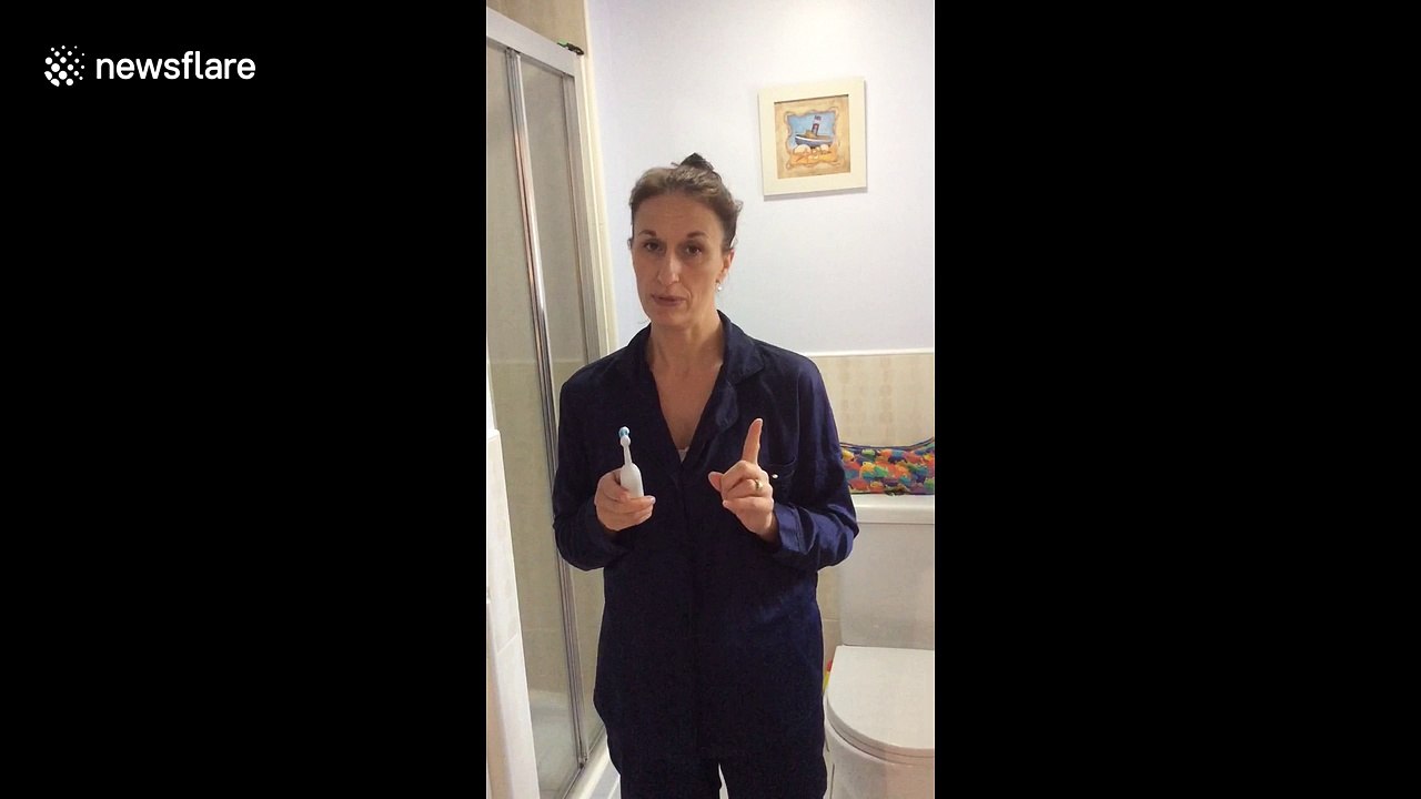 Busy mum exercises while she brushes her teeth