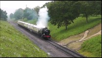 Steam Engine Puffing Past with it's Train in the English Countryside