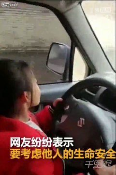 Child drives parents car while the parents guide her