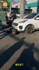 Chinese man lays under the car and begs to run over him