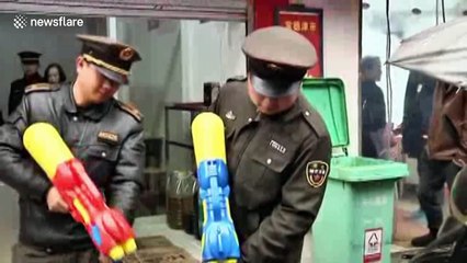 Chinese police squirt water pistols at illegal coal stoves