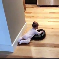 Baby Rides Robotic Vacuum Around House