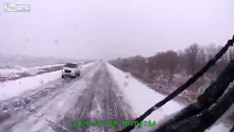 Car loses control in the snow crashing into a truck as the truck crashes into a trailer of bricks