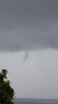 Waterspout Appears Under Clouds Offshore at River Heads
