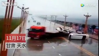 Truck loses control and it's load on rain slicked road