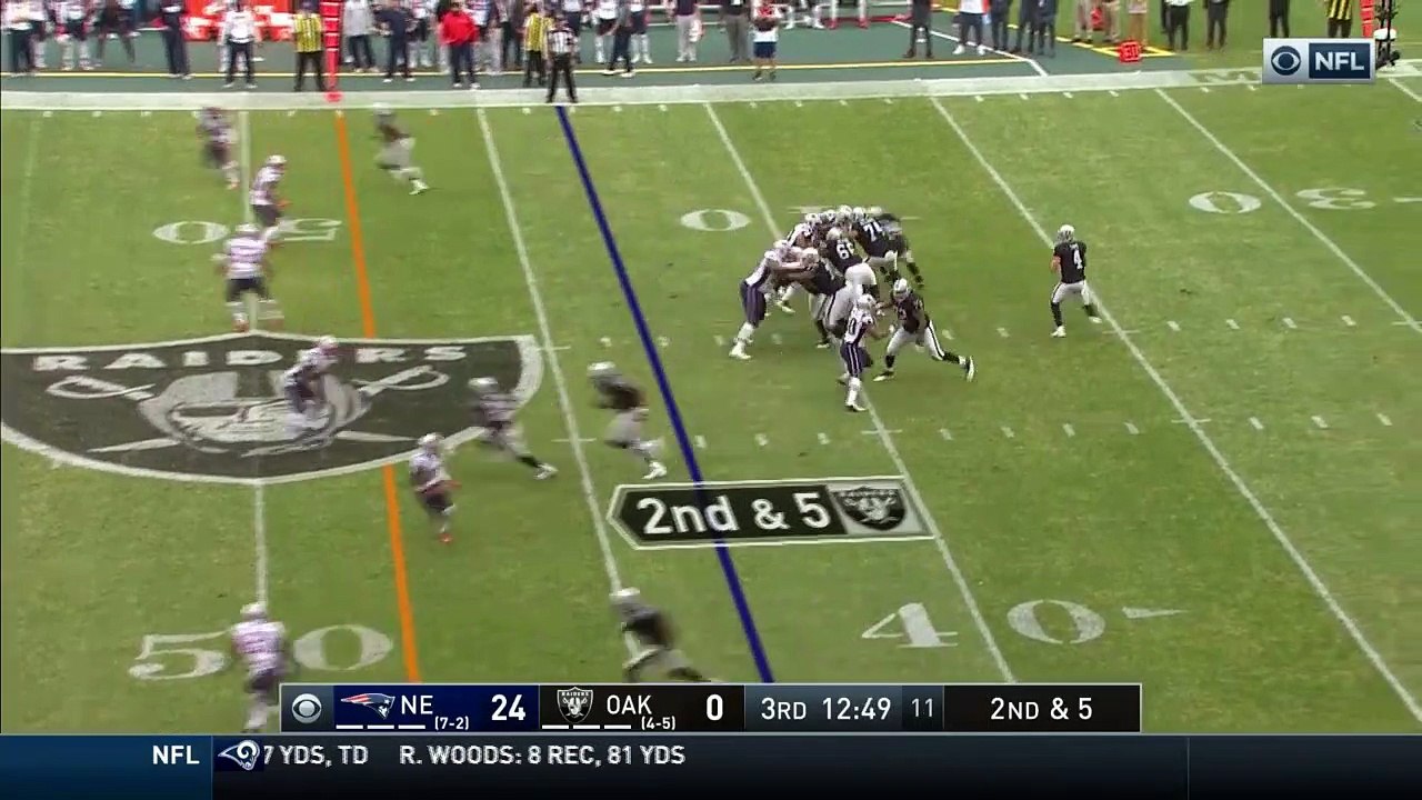 Oakland Raiders quarterback Derek Carr improvises to get ball to running back Marshawn Lynch