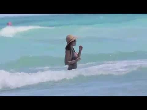 Bethenny Frankel swims in a grey swimsuit at the beach in Miami Beach