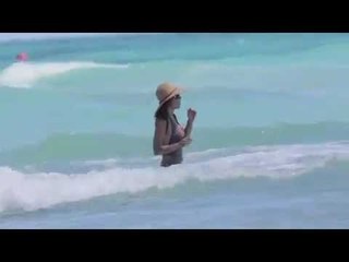 Bethenny Frankel swims in a grey swimsuit at the beach in Miami Beach