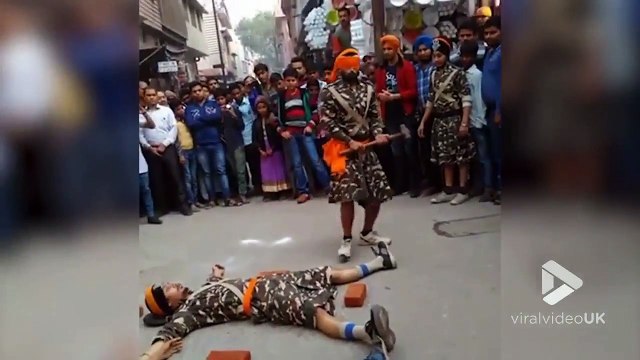 Les yeux bandés il frappe à la masse autour de gens couchés au sol !