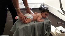 3 month old baby receives Gonstead Chiropractic BP sacrum adjustment on the knee chest table