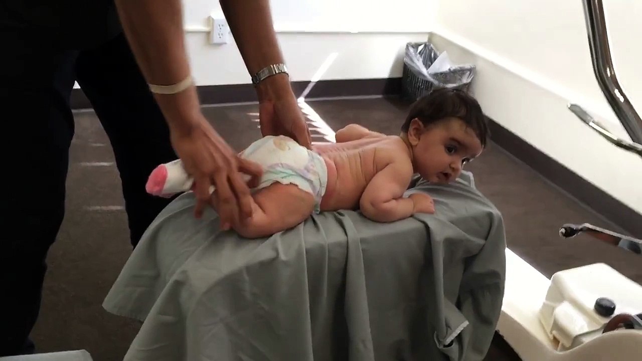 3 month old baby receives Gonstead Chiropractic BP sacrum adjustment on the knee chest table