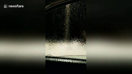 Freezing rain leaves ice sheet on car window