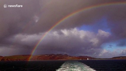 Stunning double rainbow above the sea in Scotland