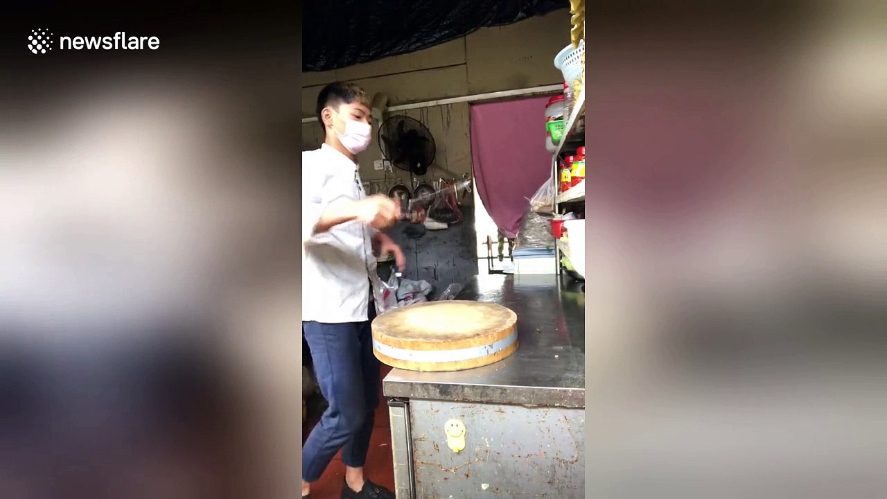 Young chef shows off meat cleaver spinning techniques