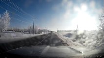 Semi-truck pulling a trailer with a bulldozer pulls down power lines