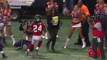 Pam Oliver dodges Devonta Freeman as he runs out of bounds