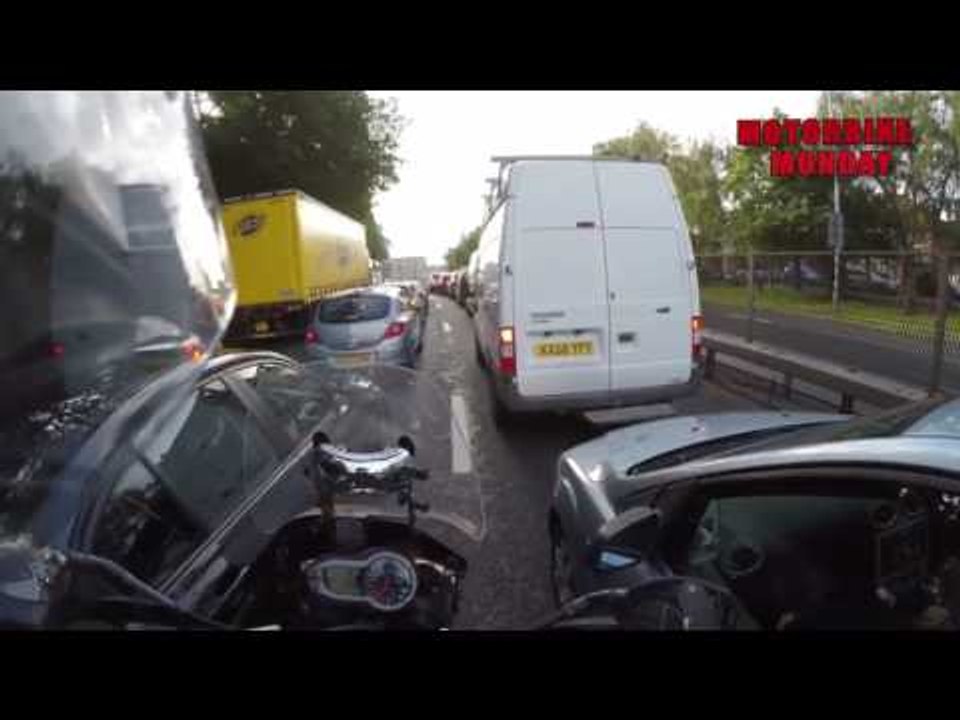 Car stuck in traffic appears to hit motorcyclist trying to get past - was it deliberate?