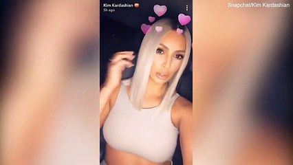Kim Kardashian flashes stomach and her hourglass figure