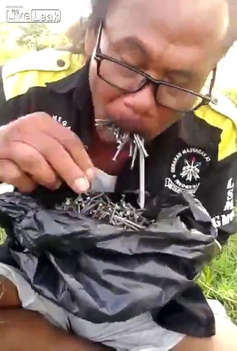 This crazy man eats a lot of nails!!