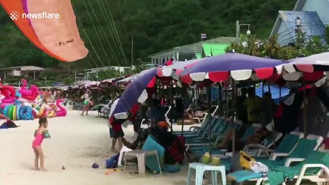 Paragliding tourist crashes into sunbathers on Thai beach