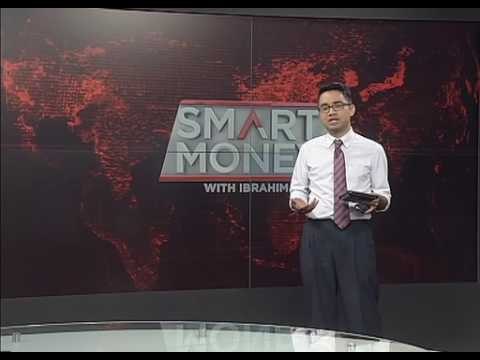 What did PETRONAS do to get profits up 12% when revenue is down considerably