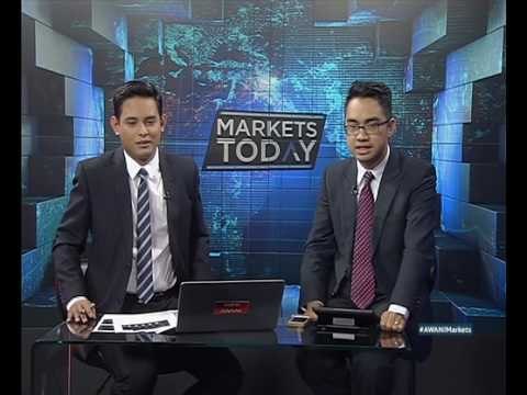 What did PETRONAS do to get profits up 12% when revenue is down considerably