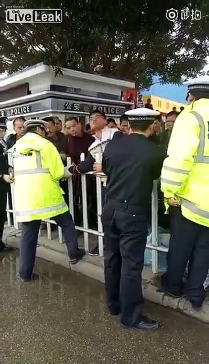 Man being tied up to guardrail
