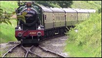 British Steam Engine with Coaches pulling into a Train Station